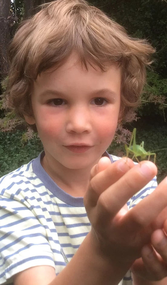 child with insect
